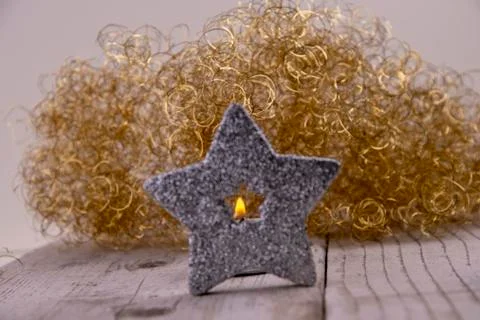 View through the silver star to the flame of a candle Stock-Fotos