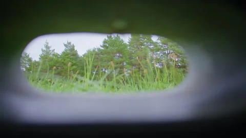A view through a small, round opening in a structure 스톡 동영상 305108427