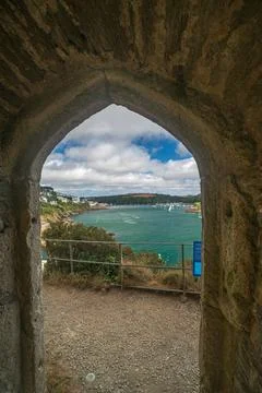 View through stone archway at St Catherines Castle to Fowey harbour and town Fotos de archivo