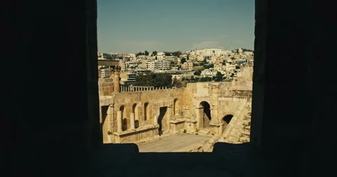 View through stone window overlooking Roman theatre in Jerash Jordan Vídeos de archivo 341515760