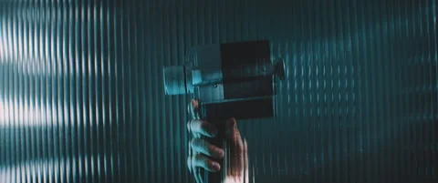 View through striped clear panel a vintage camera in blue lights Stock Footage 203569654