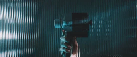 View through striped clear panel a vintage camera in blue lights Stock Footage 203569811