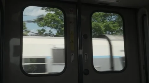 View through train doors with passing station scenery Stock Footage 335123951