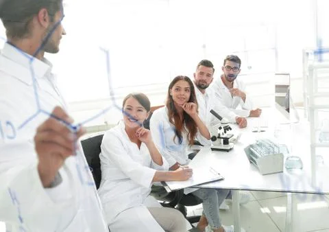View through the transparent Board. a scientist makes a report. Stock Photos