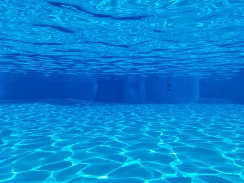 The view through a viewing port between bottom and surface of swimming pool Photos