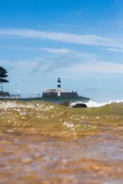 View through a wave at the Farol da Barra Stock Photos