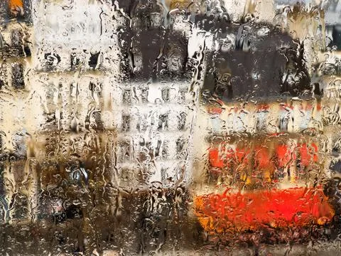 View through the wet window on roofs of Paris buildings Stock Photos