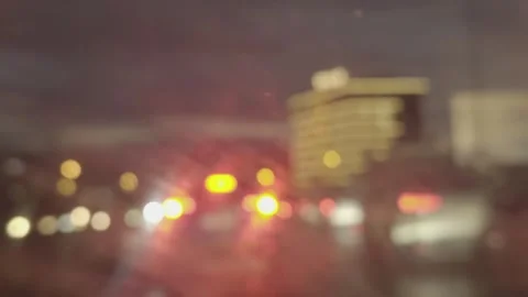 View Through Wet Windshield with Wipers and Street Traffic Stock Footage 327589853