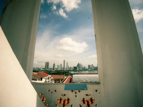 View through a white-framed window shows skyscrapers and a river Fotos de archivo