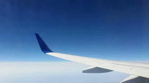 View through the window of the aircraft. The wing of the aircraft against the Video stock 107266473