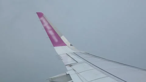 View through window of airplane while climbing into sky through cloudy of s.. Stock Footage 296088672