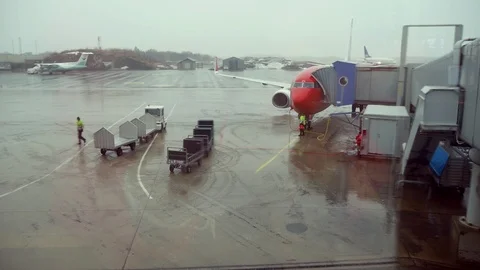 View Through Window Of Airport On Airplane Preparing For Flight In Rainy Day Stock Footage 127537145