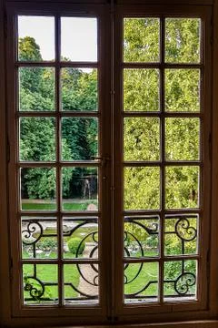 View through the window with bars on the green Park Stock Photos