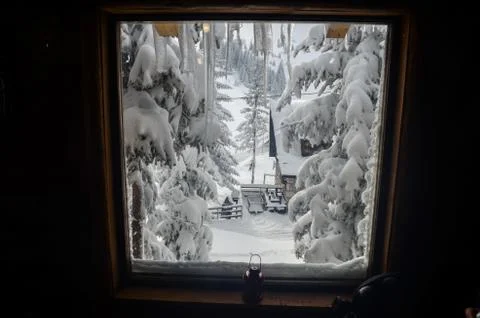 View through the window on beautiful snow covered nature during the winter. Home Stock Photos