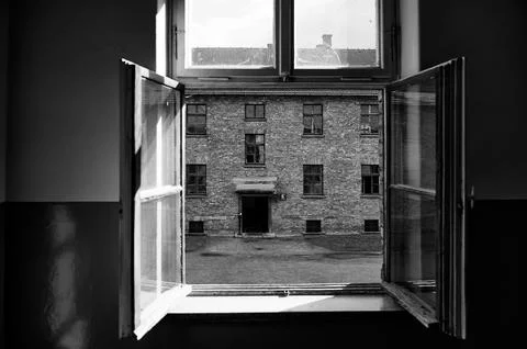 View through window of brick barracks in Auschwitz camp Stock Photos