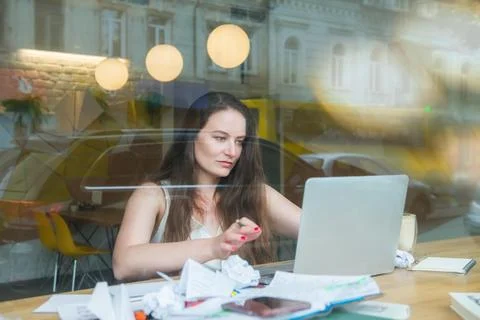 View through the window with city reflection of concentrated businesswoman Stock Photos