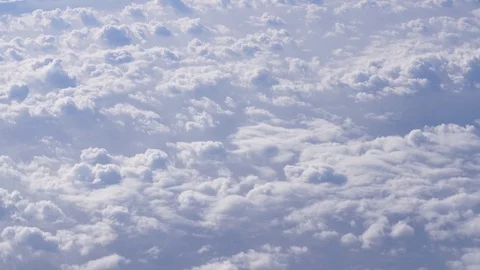 View through the window of commercial jet air plane flying above cloudy weather Stock Footage 82093443
