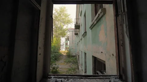 View through window to courtyard of abandoned building Video stock 165609402
