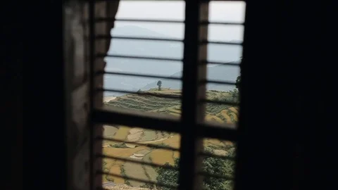 A view through window curtains of nepalese terraced rice fields. Room. Stock Footage 125809441
