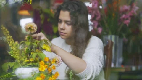 View through window glass florist makes bouquet Stock Footage 208925786