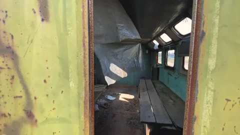 View through the window inside adandoned trailer, rusty and dirty caravan mobile Stock Footage 152910642