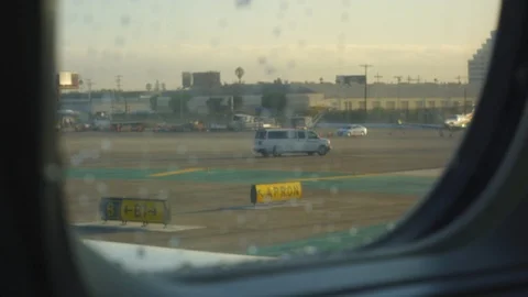 View through window from inside of moving airplane on runway Stock Footage 122184025