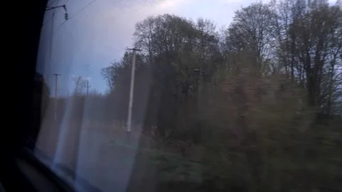 View through the window from inside a moving passenger train to nature Stock Footage 272290321