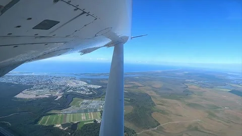The view through the window of a light aircraft as it ascends over the Stock Footage 200680937