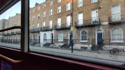 VIEW THROUGH THE WINDOW OF LONDON RED DOUBLE DECKER BUS DURING LOCKDOWN, 4K Stock Footage 128835378