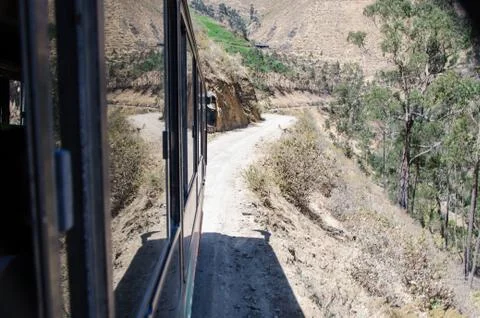 View through the window of a mountain road with forest on both sides Stock Photos