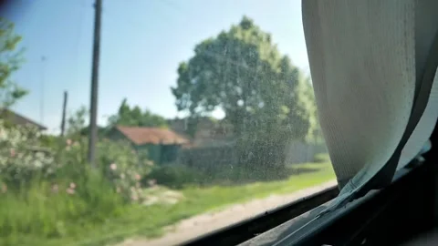 View through the window of a moving bus on the small narrow road between trees Stock Footage 222971683