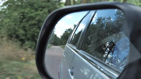 View through the window of a moving car on the rearview mirror Stock Footage 211822110