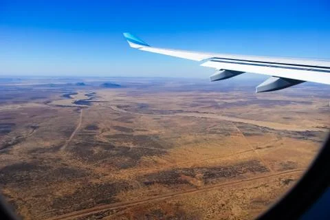 View through the window of a passenger plane flying above Namibia, Africa, ta Stock-Fotos