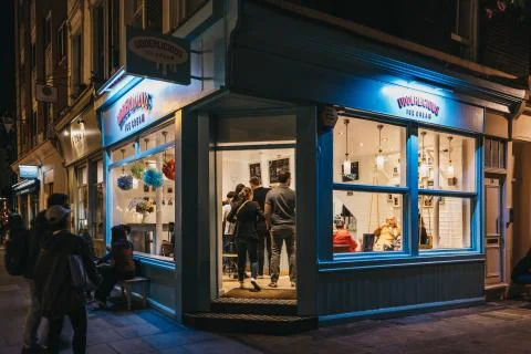 View through the window of people inside Udderlicious ice-cream shop in Coven Stock Photos