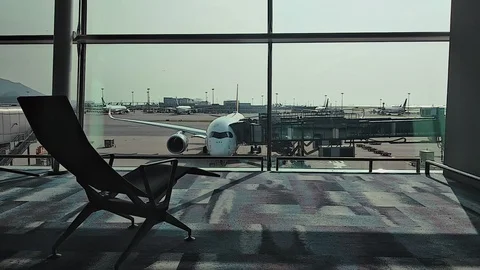 View through window of plane and exterior of airport in asian city. Stock Footage 123075382