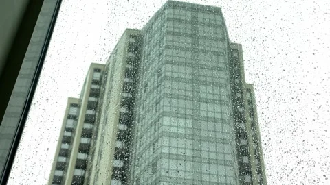 View through the window in raindrops on a neighboring high-rise building Stock Footage 240645704