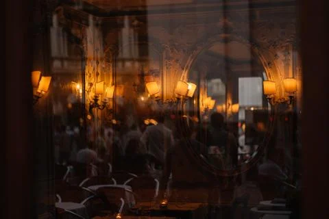 View through the window to the restaurant of Venice and the people reflected  Stock Photos