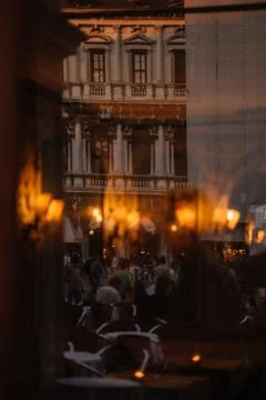 View through the window to the restaurant of Venice and the people reflected  Stock Photos
