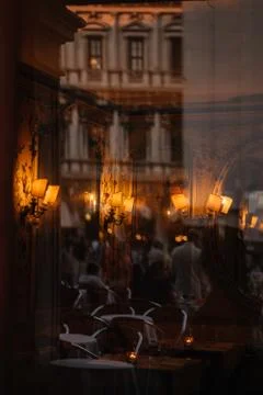 View through the window to the restaurant of Venice and the people reflected  Stock Photos