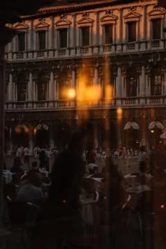 View through the window to the restaurant of Venice and the people reflected  Stock Photos