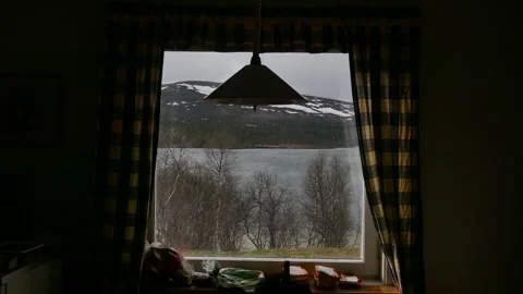 View through window of snowy mountain and lake Stock Footage 318196720