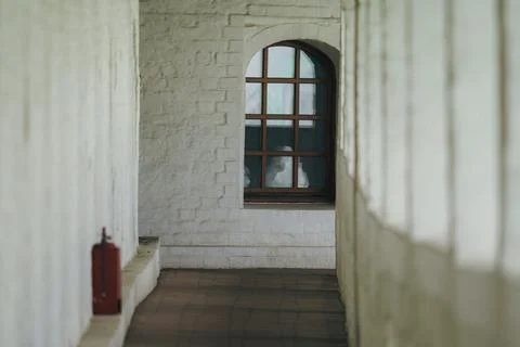 View through window in white brick corridor Stock Photos