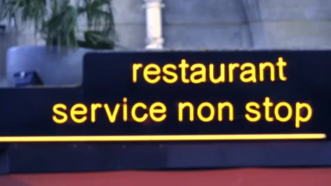 View through the windows of bus at Restaurant service non stop neon signage i Stock Footage 152596634
