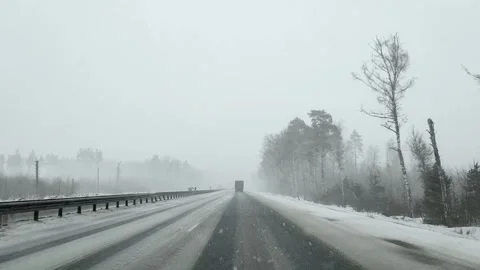 View through the windshield of a car on the autobahn in winter in heavy snowfall Stock Footage 160420095