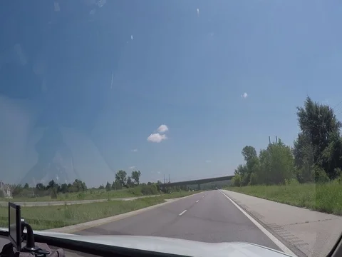 A view through the windshield of a car driving down the highway Stock-Footage 78253509