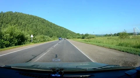 A view through the windshield of a car driving down the highway. Stock Footage 111960499