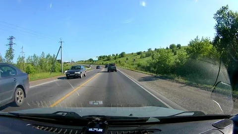 A view through the windshield of a car driving down the highway. Stock Footage 111960673