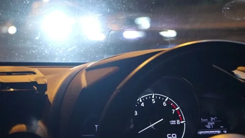 View through the windshield of a car driving in the night city Stockbeeldmateriaal 305295486