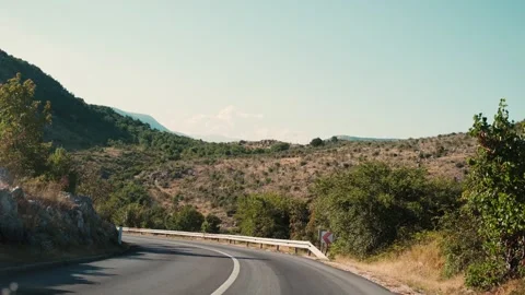 View through the windshield of the car to the mountain road Stock Footage 248287408