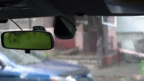 View through the windshield of a car, on a passing car in rain Stockbeeldmateriaal 195213282